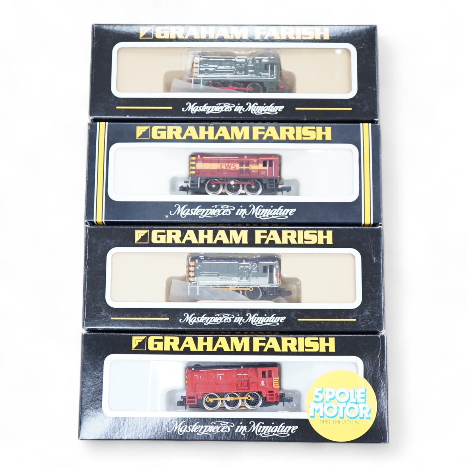 Four boxed Graham Farish N gauge railway Class 08 0-6-0 diesel locomotives; a BR, D3729 (371-001), a Railfreight Distribution, 08 653 (371-000), an EWS, 08957 (100F) and a Thomas 1, 08500 (1006).
